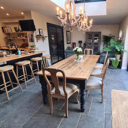 Rustic farmhouse dining table with black chunky legs and chairs