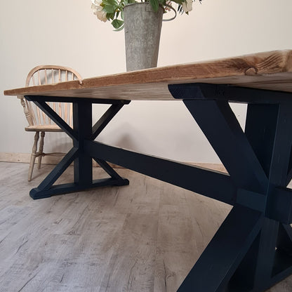 The Cross frame trestle table (pictured with the rustic pine finish)