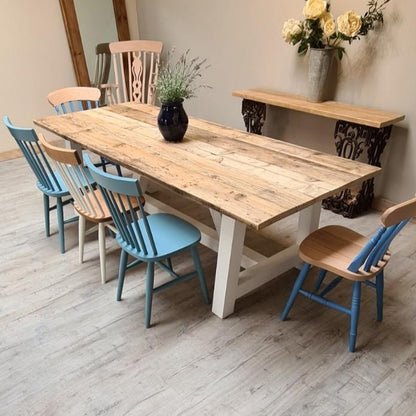 farmhouse trestle table with different colour chairs
